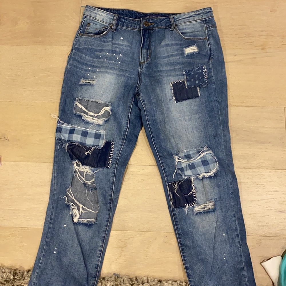 Blue jeans with flannel patches and few wholes